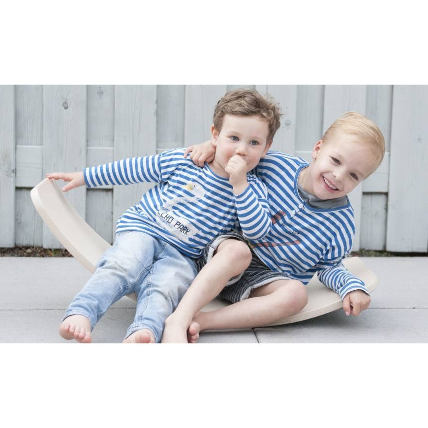 Kids sitting together and playing on a Wobbel Balance Board Rockerboard