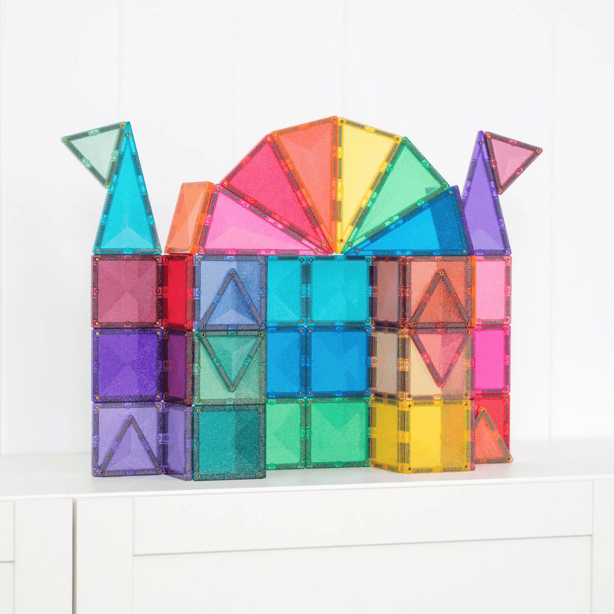 Colorful magnetic building tiles shaped like a castle on a white background