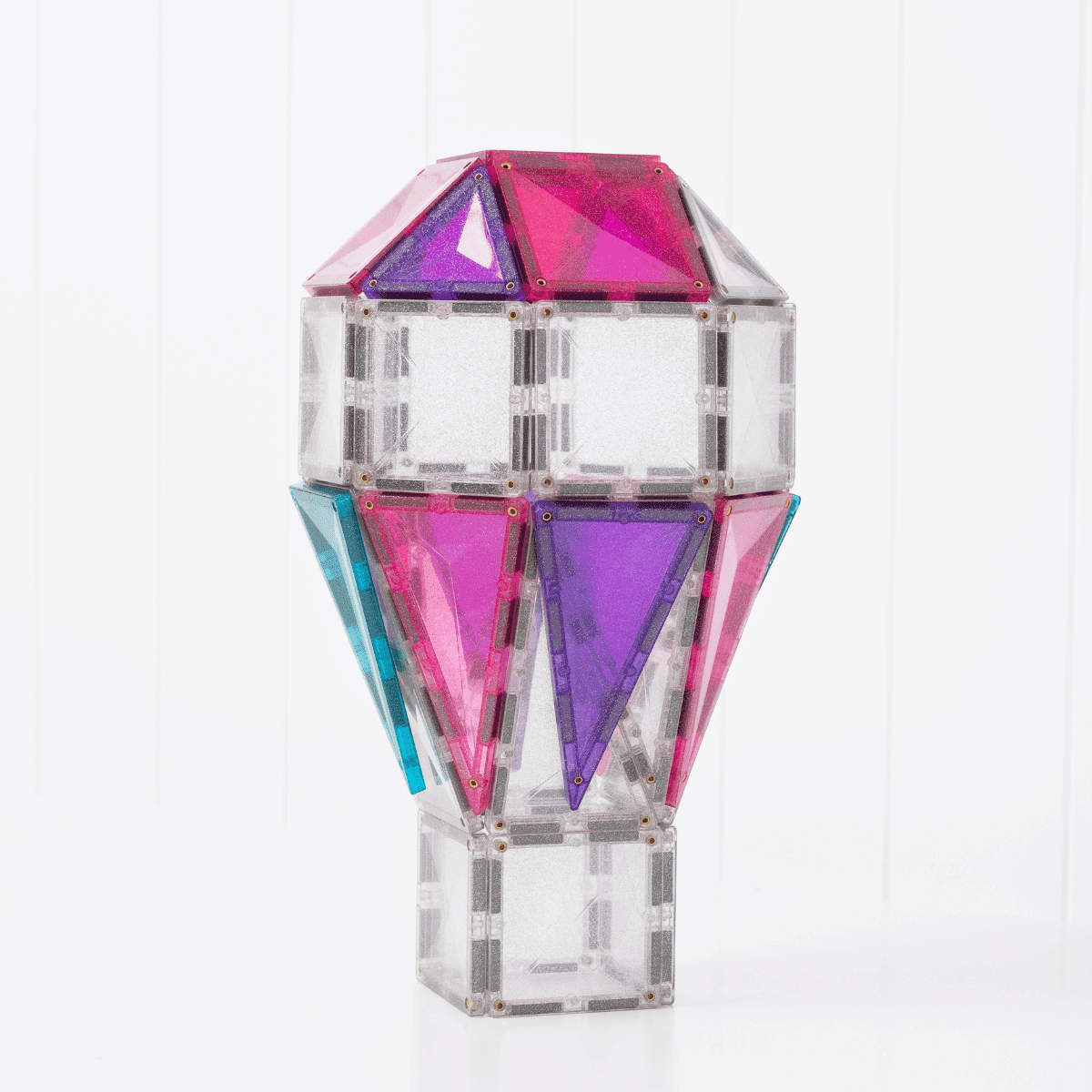 Connetix Tiles Glitter Unicorn Pack used to make a 3D hot air balloon with pink, teal, and purple accents on a white background