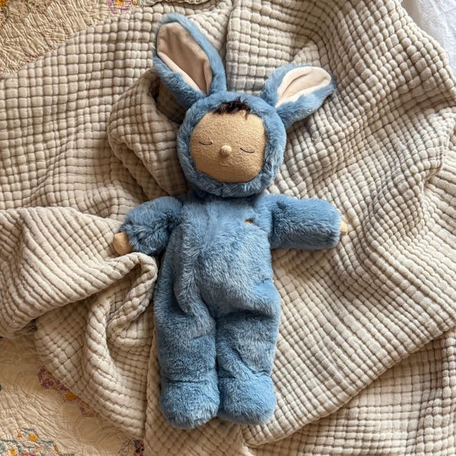 Olli Ella Cozy Dinkum Bunny Twiggy with blue plush onesie and dark tuft of hair