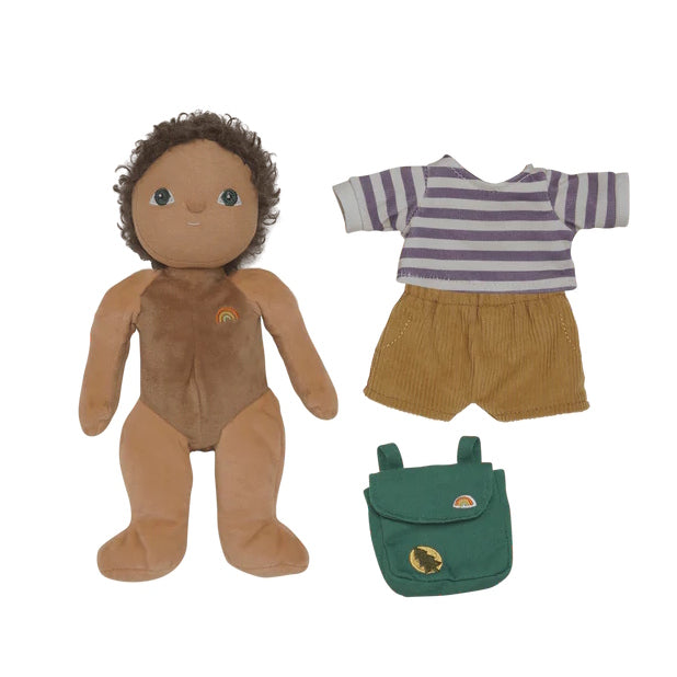 Olli Ella Dress Me Dinky Finn Fernwood a doll with brown skin and curly hair, striped shirt, mustard shorts, and green backpack on a white background