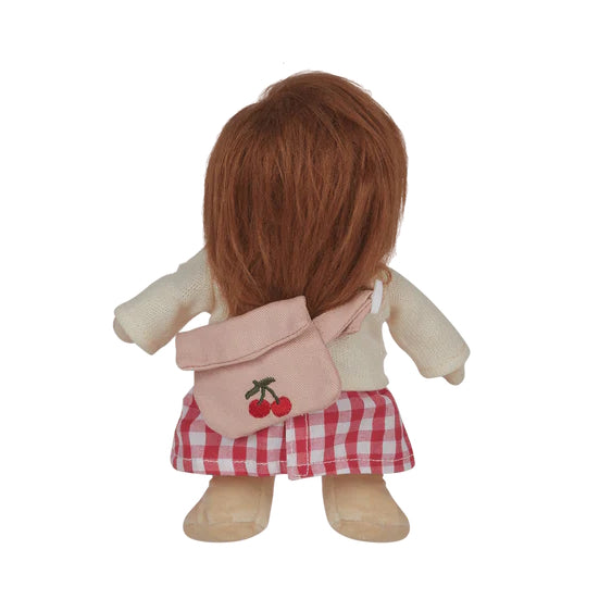 Doll with a pink backpack featuring cherry designs on a white background