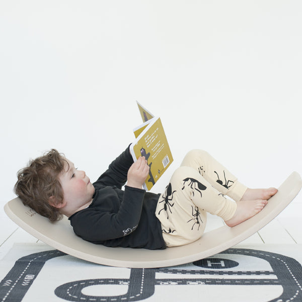 Little boy lying down on Wobbel Board